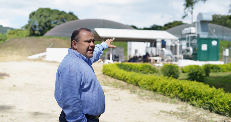 Happy entrepreneur: the biogas plant in the background generates clean energy for Saenz’ business.