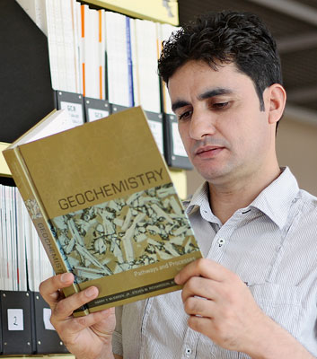 Lecturer Amanullah Zahid in the well-stocked faculty library .