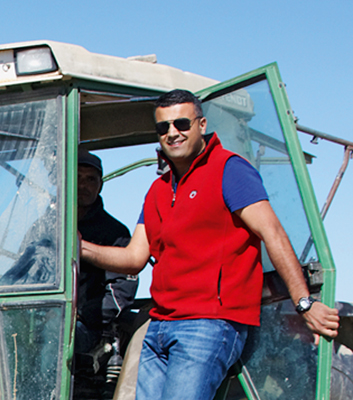 Help with the harvest: young entrepreneur Leith Tlemcani beside a vintage German tractor.