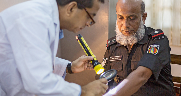 Hautarzt Mohammed Ali Chowdhury stellt schnell fest, dass Polizist Ali Hossain zu einem anderen Experten muss: Die Datenbank sagt ihm, dass der Mann Diabetes hat – vermutlich die Ursache seiner Beschwerden.
