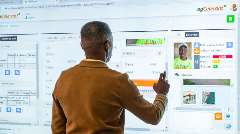 Man standing in front of a big screen.